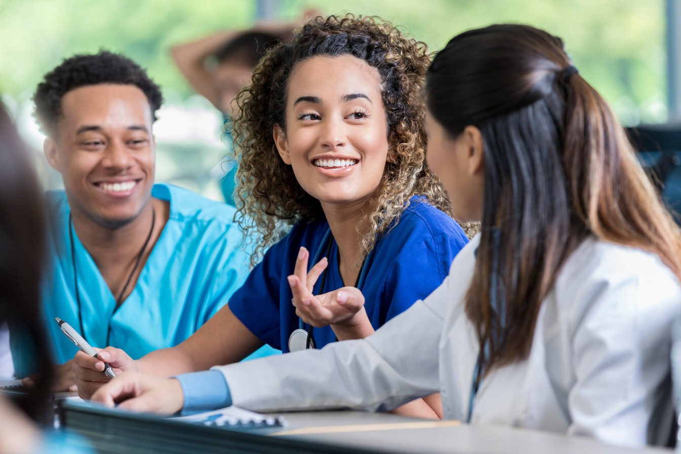 Cheerful nursing student talking with friends