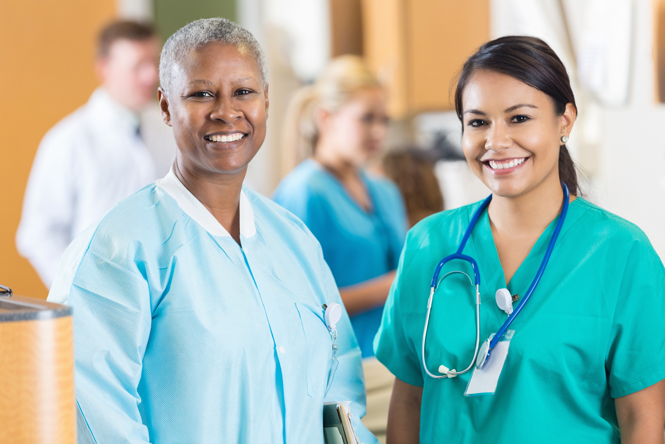 Mature phlebotomist with nurse in hospital blood donation center